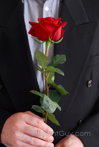 groom holding a rose during a rose ceremony during Southern California weddings